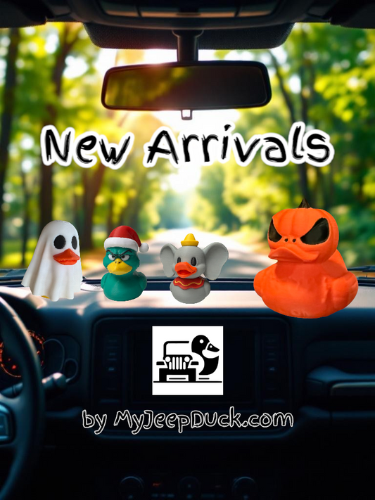 A collection of new Jeep adventure companions including a spooky sheet ghost duck, a grumpy green Christmas duck, and a whimsical flying elephant duck, all ready for off-road fun.